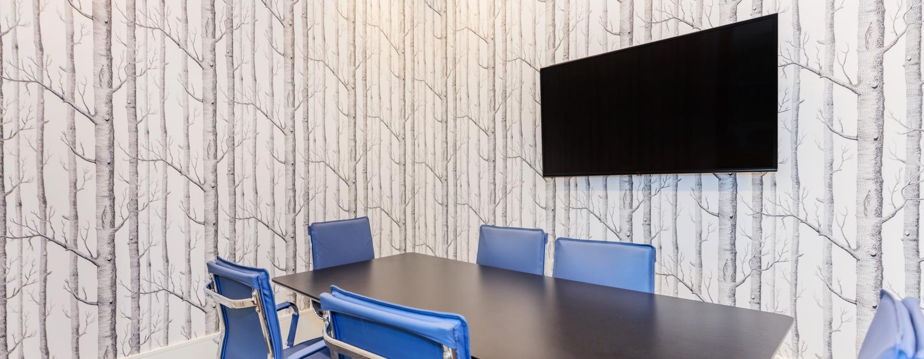 a table with chairs around it in a meeting room