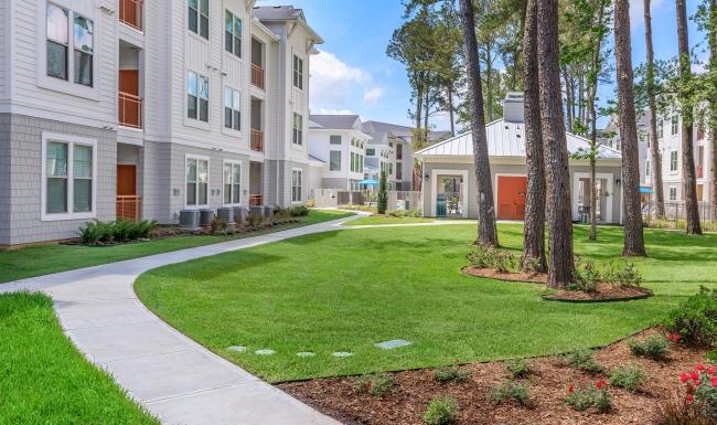 A perfect fit for the whole family outdoor green area with trees in front a building