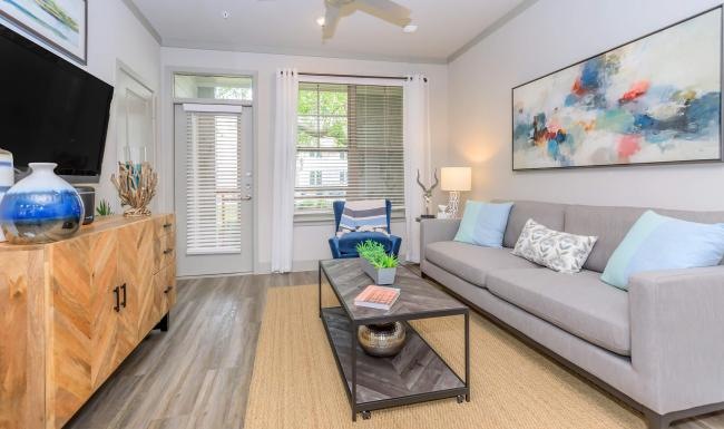 All the comforts of luxury living a living room with a couch and a coffee table